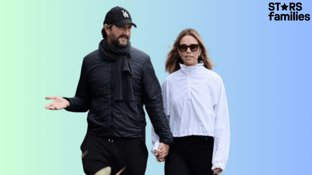 Josh Connor Financier walks alongside a woman, both enjoying a leisurely stroll down the street.