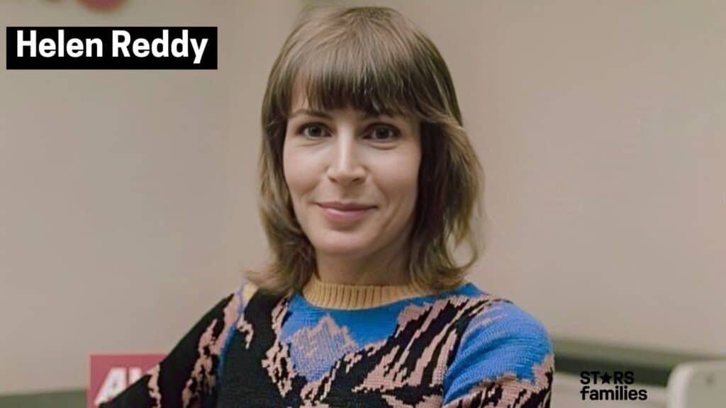 Helen Reddy is wearing a colorful sweater with a mountain pattern.