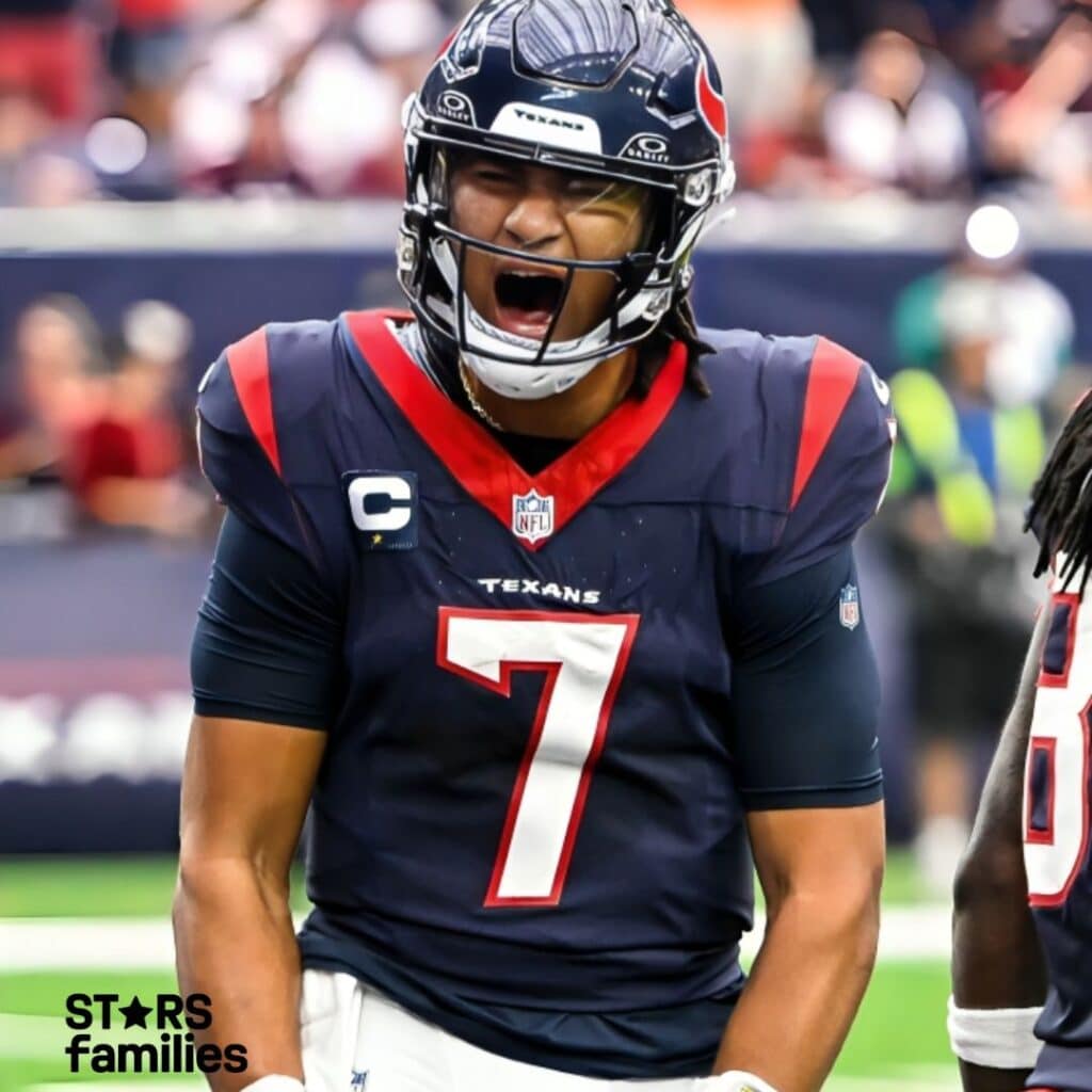 C.J. Stroud, wearing a Houston Texans navy blue jersey with red and white accents and the number 7, stands on the field. He has a captain's patch on the right side of his chest and the NFL logo at the base of the collar. The helmet is navy blue with the Texans' logo on the side.