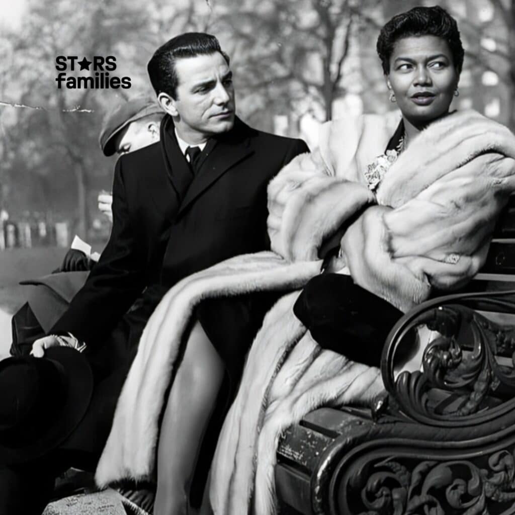 In a black-and-white vintage photo, Pearl Bailey, dressed in a fur coat and heels, is seated on a park bench next to her husband, who is in a dark suit and holding a hat.