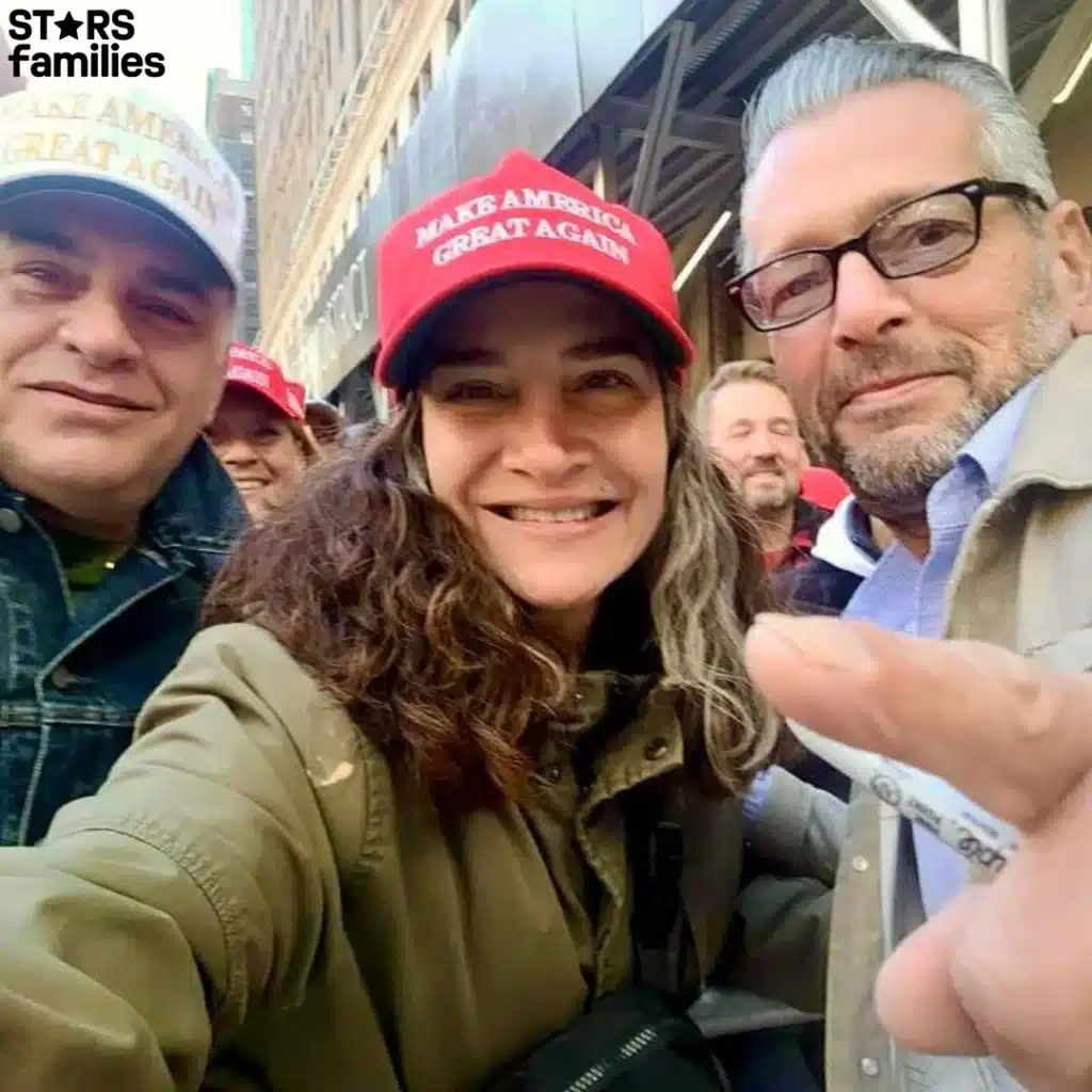 Scott Lobaido poses with a man and woman for a selfie, all smiling, with the man wearing a stylish hat.